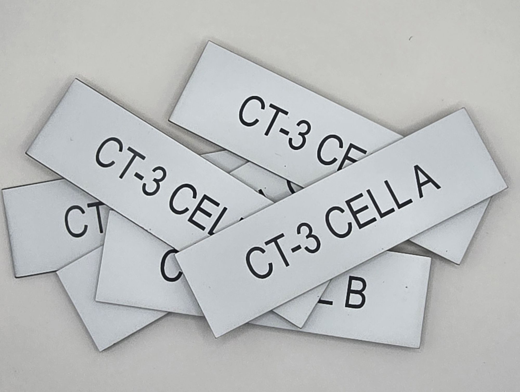 Black-on-white engraved cell labels